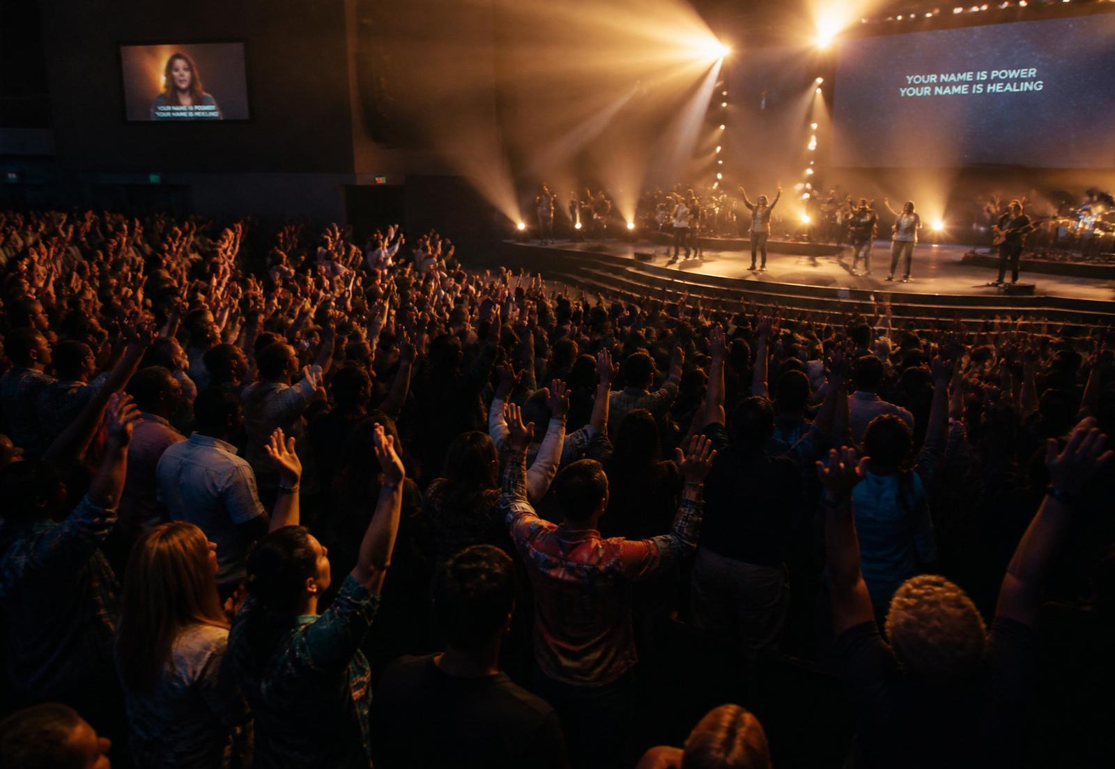 Congregation with hands raised during worship